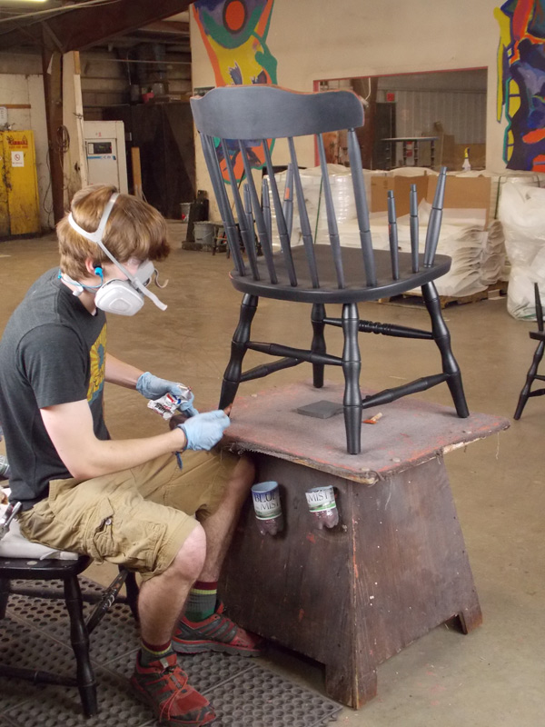 applying final coat to awards chair